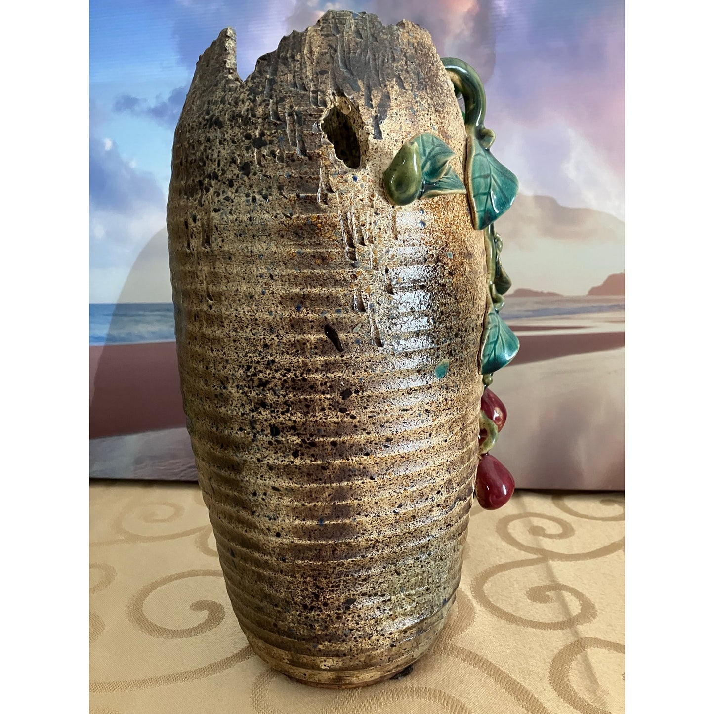 Shiwan pottery vase adorned with deep red cherry and green vines